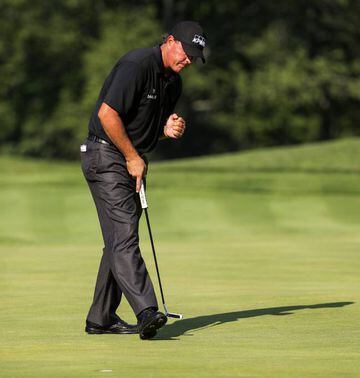 Phil Mickelson of the US reacts as he sinks a putt on the eleventh green during the second round of the PGA Championship