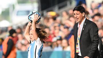 Argentina's forward #22 Estefania Banini throws the ball in front of coach German Portanova during the Australia and New Zealand 2023 Women's World Cup Group G football match between Argentina and South Africa at Dunedin Stadium in Dunedin on July 28, 2023. (Photo by Sanka Vidanagama / AFP)