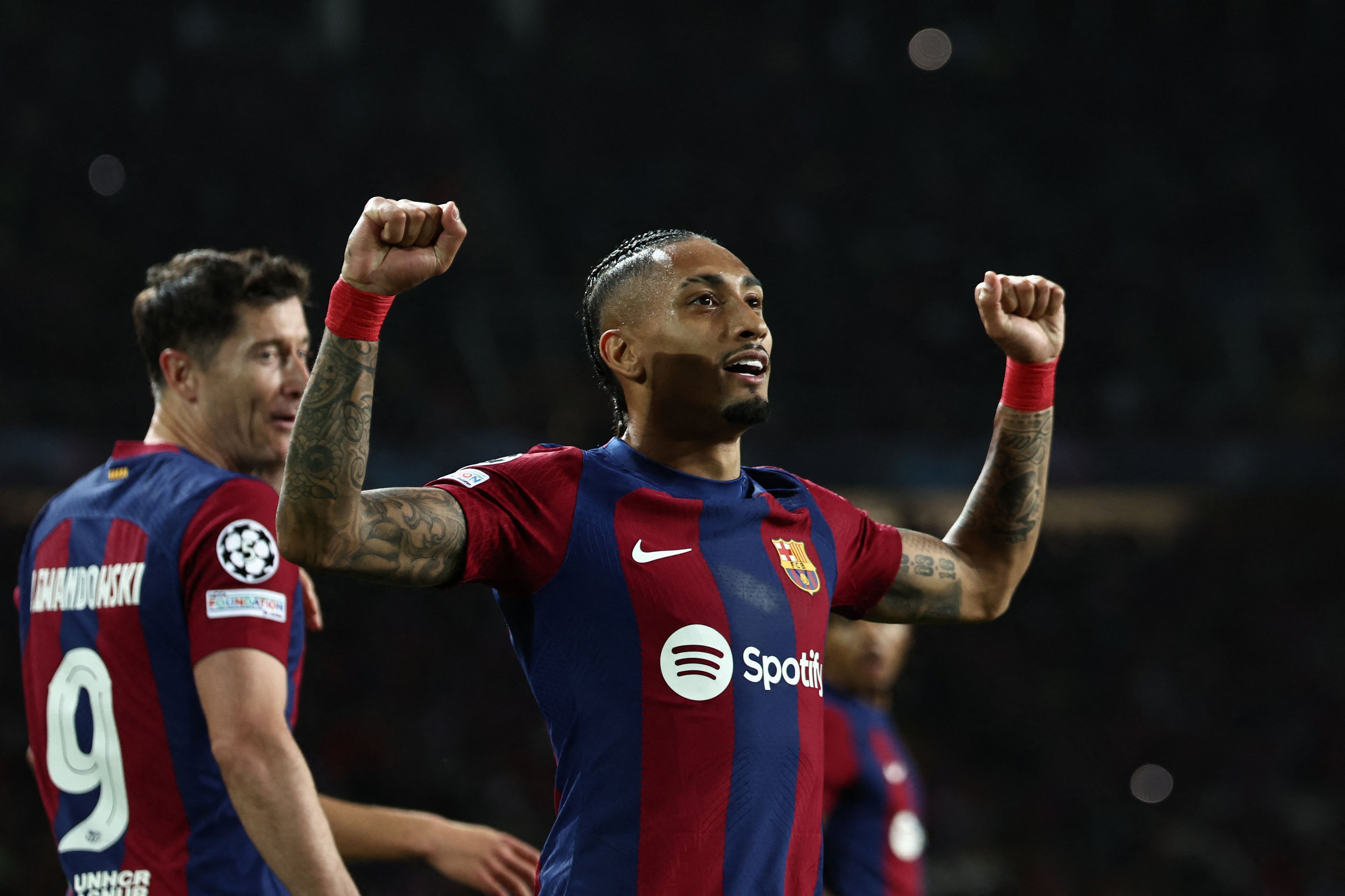 Barcelona's Brazilian forward #11 Raphinha celebrates after scoring his team's first goal during the UEFA Champions League quarter-final second leg football match between FC Barcelona and Paris SG at the Estadi Olimpic Lluis Companys in Barcelona on April 16, 2024. (Photo by FRANCK FIFE / AFP)