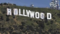 Banners, to read "Rams House", are installed over the Hollywood sign in Los Angeles, California, on February 14, 2022. - The temporary display will be installed to celebrate the Los Angeles Rams victory over the Cincinnati Bengals in Superbowl LVI on February 13. (Photo by Patrick T. FALLON / AFP)