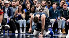 Feb 2, 2023; Dallas, Texas, USA; Dallas Mavericks guard Luka Doncic (77) kneels on the floor after he is fouled by New Orleans Pelicans forward Brandon Ingram (not pictured) as he drives to the basket during the second half at the American Airlines Center. Mandatory Credit: Jerome Miron-USA TODAY Sports