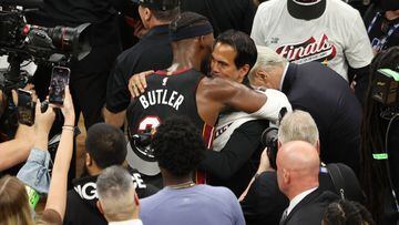 Jimmy Butler #22 of the Miami Heat hugs head coach Erik Spoelstra