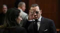 Actor Johnny Depp gestures while departing the courtroom during a defamation case against his ex-wife, actor Amber Heard, at Fairfax County Circuit Courthouse in Fairfax, Virginia, U.S., May 17, 2022. Brendan Smialowski/Pool via REUTERS