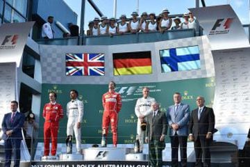 Sebastian Vettel (centre) on the Melbourne podium with second-placed Lewis Hamilton (third left) and third-placed Valtteri Bottas (fourth right)