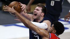 DALLAS, TEXAS - APRIL 12: Luka Doncic #77 of the Dallas Mavericks draws a foul from Tobias Harris #12 of the Philadelphia 76ers in the first quarter at American Airlines Center on April 12, 2021 in Dallas, Texas. NOTE TO USER: User expressly acknowledges 