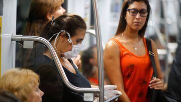 A woman uses a cellphone while she wears a protective face mask as a preventive measure against the outbreak of the coronavirus disease (COVID-19), at the subway in Buenos Aires, Argentina March 17, 2020. REUTERS/Agustin Marcarian