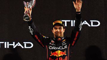 ABU DHABI, UNITED ARAB EMIRATES - NOVEMBER 20: Third placed Sergio Perez of Mexico and Oracle Red Bull Racing celebrate on the podium during the F1 Grand Prix of Abu Dhabi at Yas Marina Circuit on November 20, 2022 in Abu Dhabi, United Arab Emirates. (Photo by Rudy Carezzevoli/Getty Images)
