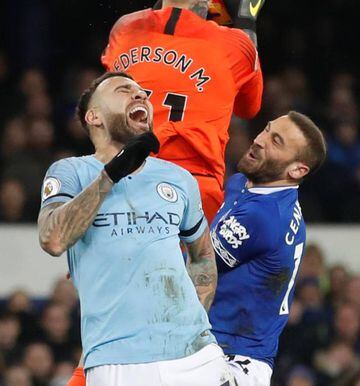 Manchester City's Ederson and Nicolas Otamendi in action with Everton's Cenk Tosun