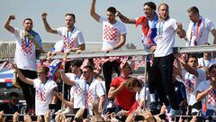 Croatian national football team members ride an open-roof coach in Zagreb International Airport on July 16, 2018 after their return from the FIFA World Cup 2018 in Russia in Zagreb International Airport on July 16, 2018.   / AFP PHOTO / ATTILA KISBENEDEK