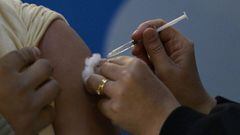 A member of the Armed Forces is being inoculated against the novel coronavirus COVID-19 with the AstraZeneca/Oxford vaccine obtained through the Covax scheme, at the CCK Cultural Centre in Buenos Aires on June 15, 2021. (Photo by Juan MABROMATA / AFP)