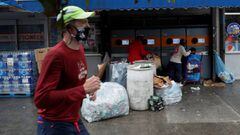 A jogger wearing a protective face mask runs by a recycling center as the spread of covid-19 continues, in the borough of Brooklyn, in New York, U.S., October 13, 2020. REUTERS/Shannon Stapleton