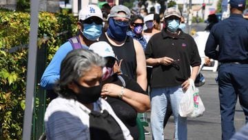 People wait in line at a walk-up coronavirus testing location in Los Angeles, California, August 10, 2020, amid the COVID-19 pandemic. - Los Angeles County officials reported 1,920 new confirmed cases of coronavirus on August 10, bringing the total to at 