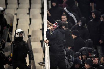 AEK Athens fans jumped onto the pitch and launched flares at the Ajax fans in the Champions League game in Greece on Tuesday night, causing police to intervene.