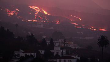 Lava flows down a hill spewed by the Cumbra Vieja volcano as it continues to erupt on the Canary Island of La Palma, as seen from Tajuya, Spain, October 16, 2021. REUTERS/Sergio Perez