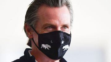 (FILES) In this file photo California Governor Gavin Newsom arrives to brief the media on the opening day of a new mass Covid-19 vaccination site established between the federal government and the state on February 16, 2021 on the campus at California Sta