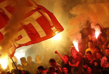 Red Star soccer fans light torches during a Serbian National soccer league derby match between Partizan and Red Star, in Belgrade, Serbia, Saturday, Sept. 17, 2016.