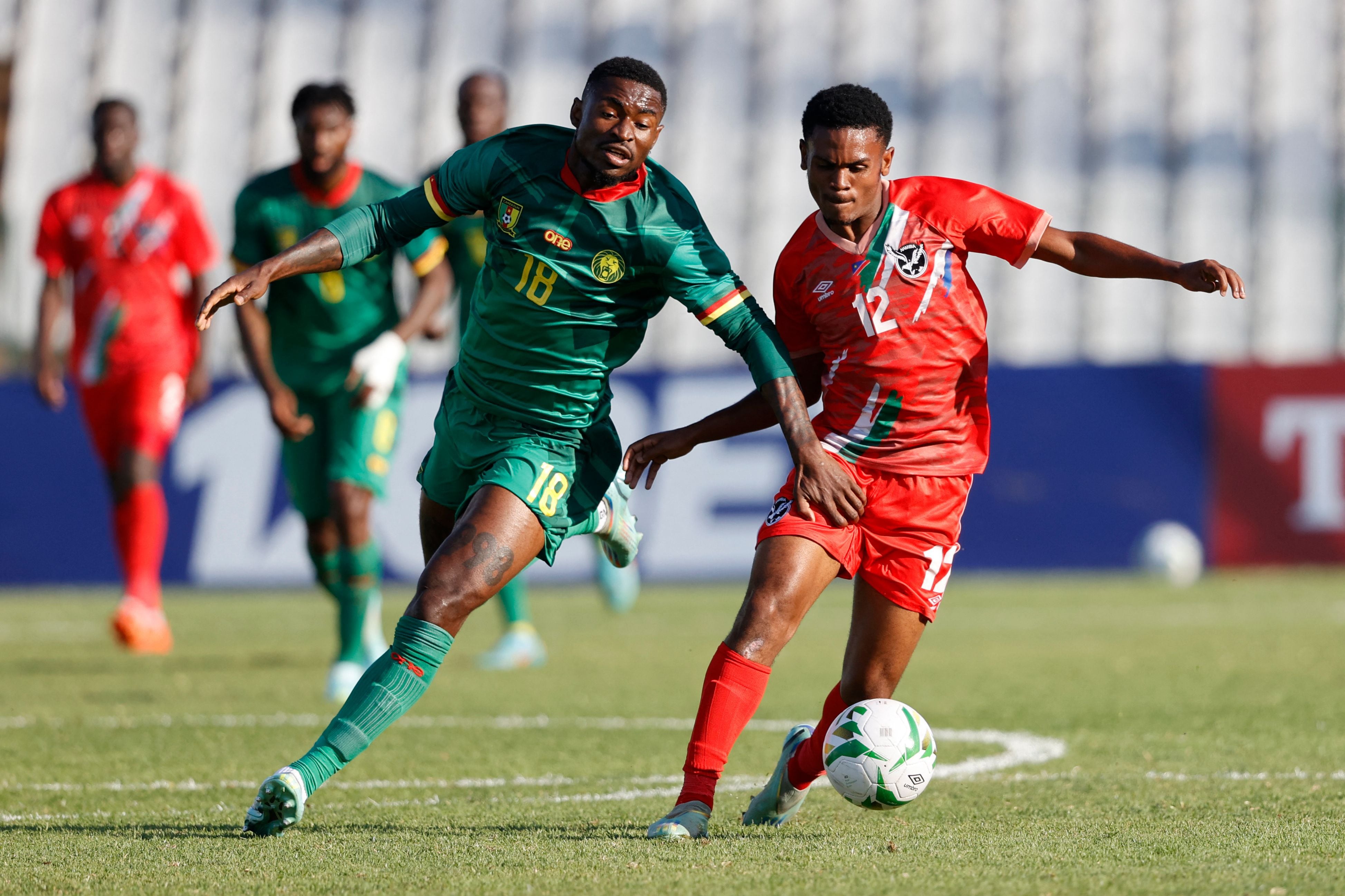 Namibia's Edmar Kamatuka (R) is challenged by Cameroon's Martin Hongla (L) during the 2023 Africa Cup of Nations (CHAN) Group C qualifier match between Namibia and Cameroon at the Dobsonville Stadium in Soweto on March 28, 2023. (Photo by PHILL MAGAKOE / AFP)