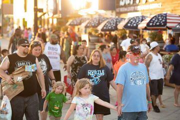 People walk towards the beach at Ninth Ave. on May 23, 2020 in Myrtle Beach, South Carolina. Businesses, including amusement parks, have reopened for the Memorial Day holiday weekend after forced pandemic closures.