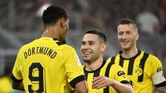 (L to R) Dortmund's French forward Sebastien Haller celebrates with Dortmund's Portuguese defender Raphael Guerreiro and Dortmund's German forward Marco Reus scoring the second goal for Dortmund during the German first division Bundesliga football match between Borussia Dortmund and FC Cologne in Dortmund on March 18, 2023. (Photo by INA FASSBENDER / AFP) / DFL REGULATIONS PROHIBIT ANY USE OF PHOTOGRAPHS AS IMAGE SEQUENCES AND/OR QUASI-VIDEO