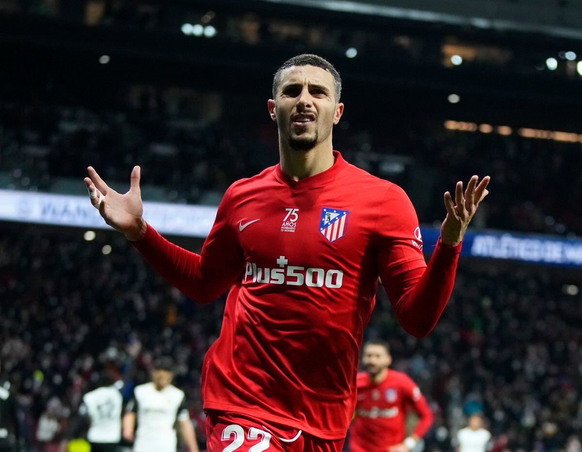 Atletico Madrid's Mario Hermoso, left, celebrates after scoring his side's third goal during a Spanish La Liga soccer match between Atletico Madrid and Valencia at the Wanda Metropolitano stadium in Madrid, Spain, Saturday, Jan. 22, 2022. (AP Photo/Manu Fernandez)