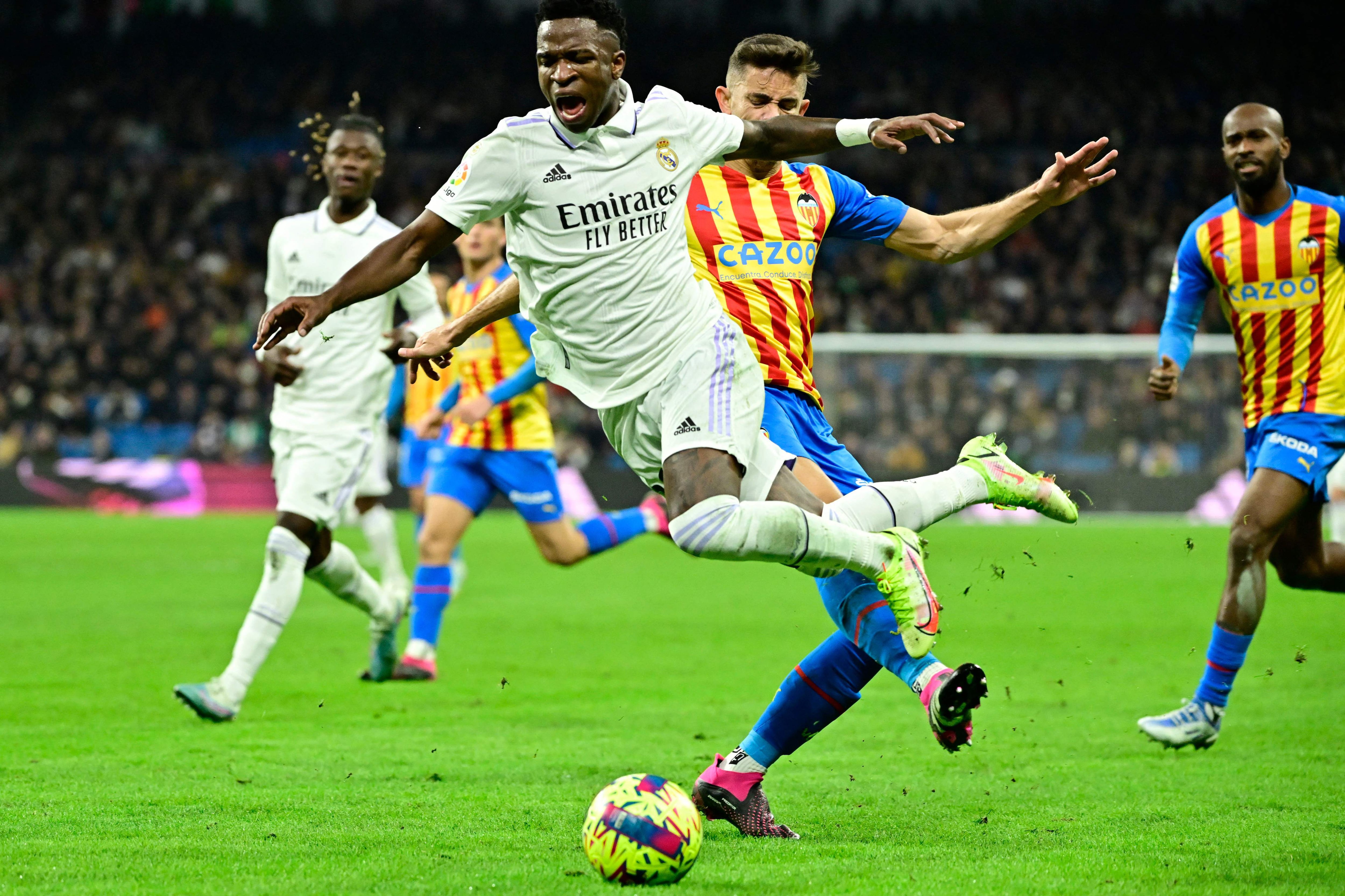 Valencia's Brazilian defender Gabriel Paulista (R) fouls Real Madrid's Brazilian forward Vinicius Junior during the Spanish league football match between Real Madrid CF and Valencia CF at the Santiago Bernabeu stadium in Madrid on February 2, 2023. (Photo by JAVIER SORIANO / AFP)