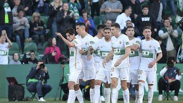 Elche's Spanish midfielder Pere Milla (L) celebrates with teammates after scoring a goal during the Spanish league football match between Elche CF and Villarreal CF at the Martinez Valero stadium in Elche, on February 4, 2023. (Photo by Jose Jordan / AFP)