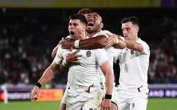 England's scrum-half Ben Youngs (L) celebrates with England's centre Henry Slade (back L), England's centre Manu Tuilagi and England's fly-half George Ford (R)