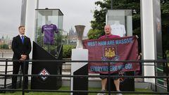 A fan of West Ham United poses next to the Conference League Trophy that is displayed in front the Prague Castle on the eve of the UEFA Europa Conference League 2022/23 final match between ACF Fiorentina and West Ham United FC on June 6, 2023 in Prague, Czech Republic. (Photo by STRINGER / AFP)