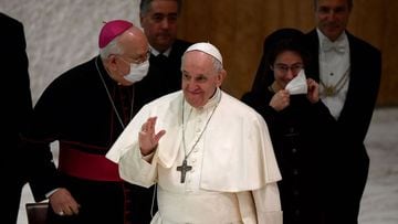 Pope Francis waves next to Secretary-general of the governorate Sister Raffaella Petrini (R), the first-ever woman to head the governorate of the Vatican City, during an audience with the Vatican employees for the Christmas greetings in the Paul VI Hall a