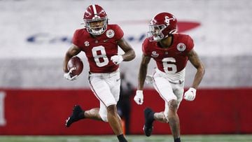 ARLINGTON, TEXAS - JANUARY 01: Wide receiver John Metchie III #8 of the Alabama Crimson Tide carries the football behind the wide receiver DeVonta Smith #6 against the Notre Dame Fighting Irish in the 2021 College Football Playoff Semifinal Game at the Ro