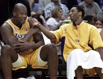 Kobe Bryant and Shaquille O'Neal joke on the sidelines during a game in 2002. They were about to win their third championship in a row.
