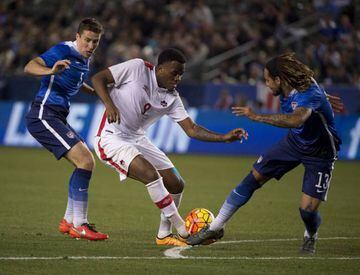 Canada striker Cyle Larin attempts to beat USMNT midfielder Jermaine Jones during last night's clash in LA.