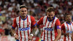Girona's Spanish midfielder #14 Aleix Garcia (C) celebrates scoring his team's second goal during the Spanish Liga football match between Sevilla FC and Girona FC at the Ramon Sanchez Pizjuan stadium in Seville on August 26, 2023. (Photo by CRISTINA QUICLER / AFP)