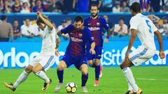 MIAMI GARDENS, FL - JULY 29: Lionel Messi #10 of Barcelona scores against the defense of Raphael Varane #5 and Luka Modric #10 of Real Madrid in the first half during their International Champions Cup 2017 match at Hard Rock Stadium on July 29, 2017 in Mi