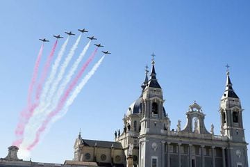 Spanish elite acrobatic flying team "Patrulla Aguila" (Eagle Patrol) perform aerobatics and release trails of red and yellow smoke representing the Spanish flag during the National Day Military Parade at the Royal Palace on October 12, 2020 in Madrid, Spa