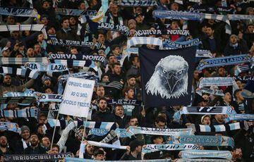 Lazio fans hold up scarves and display banners REUTERS/Tony Gentile