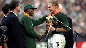 South Africa captain Francois Pienaar receives the William Webb Ellis Trophy from Nelson Mandela