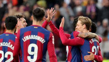 Barcelona's Dutch midfielder #21 Frenkie de Jong (R) celebrates with teammates scoring his team's third goal with teammates during the Spanish league football match between FC Barcelona and Getafe CF at the Estadi Olimpic Lluis Companys in Barcelona on February 24, 2024. (Photo by LLUIS GENE / AFP)