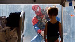 A man dressed as a Spiderman jokes with a child hospitalized in the pediatrics ward of the San Paolo hospital, in Milan, Italy, December 15, 2021. 