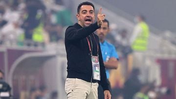 Al Sadd coach Xavi speaks to his players during the Amir Cup final football match between Al-Sadd and Al-Rayyan at the Al-Thumama Stadium in the capital Doha. 