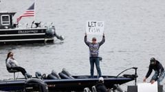 A man holds a &quot;let us fish&quot; sign from his boat on Lake Union to protest against the recreational fishing ban in Washington State, in place until at least May 4 due to the coronavirus disease (COVID-19) outbreak, in Seattle, Washington, U.S. Apri