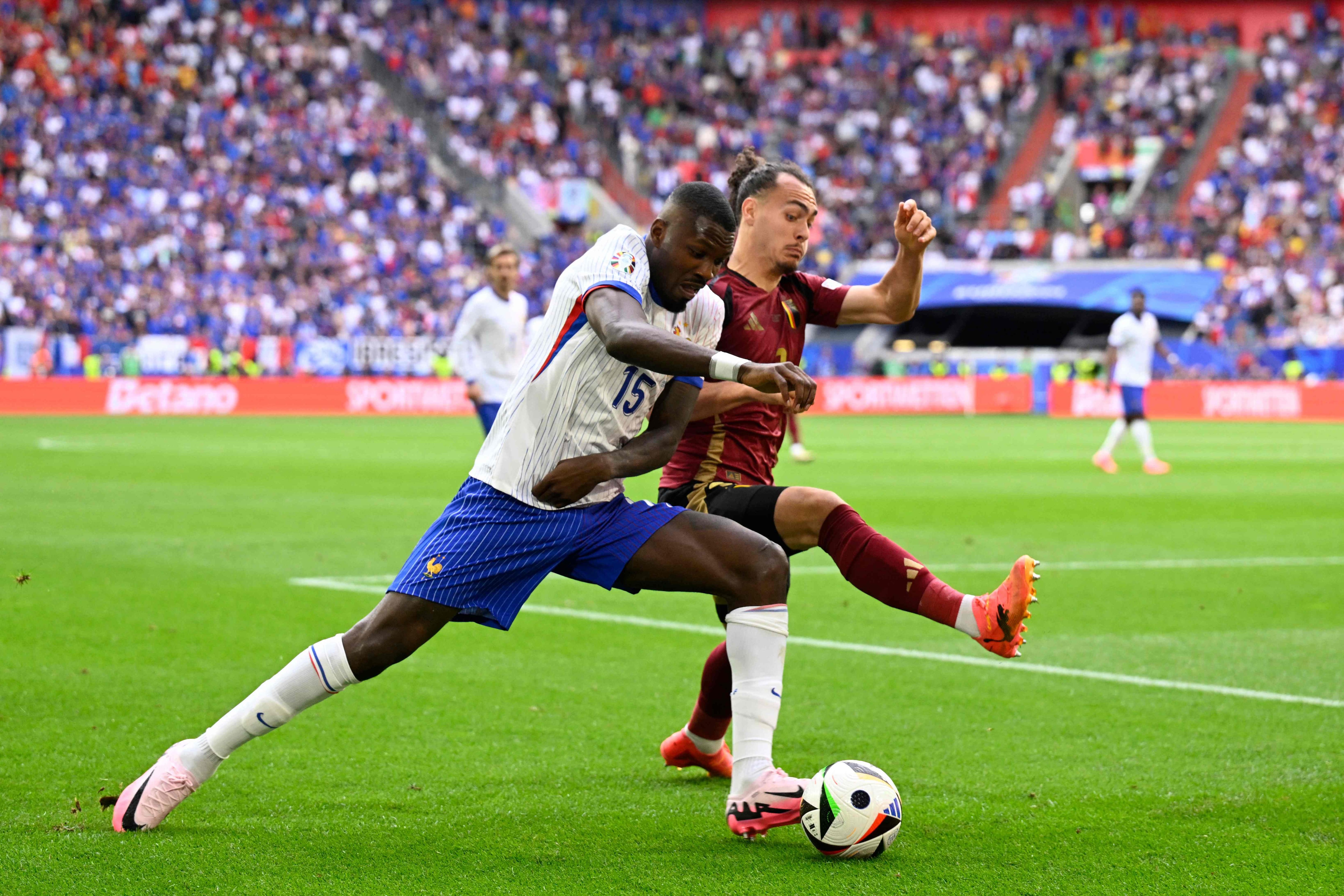 Arthur Theate (R) tackles France's forward #15 Marcus Thuram (L) during the UEFA Euro 2024 round of 16 football match between France and Belgium at the Duesseldorf Arena in Duesseldorf on July 1, 2024. (Photo by INA FASSBENDER / AFP)