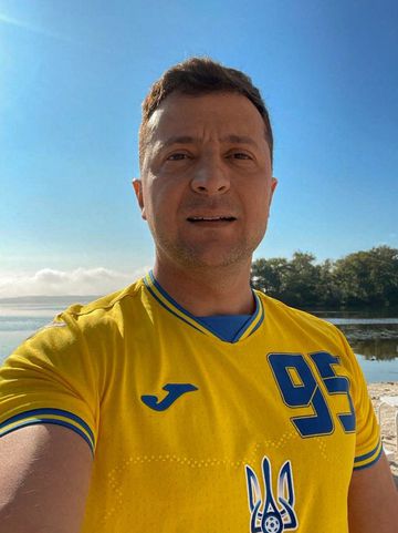 Ukrainian President Volodymyr Zelensky making a selfie wearing Ukraine&#039;s national football team shirt.
