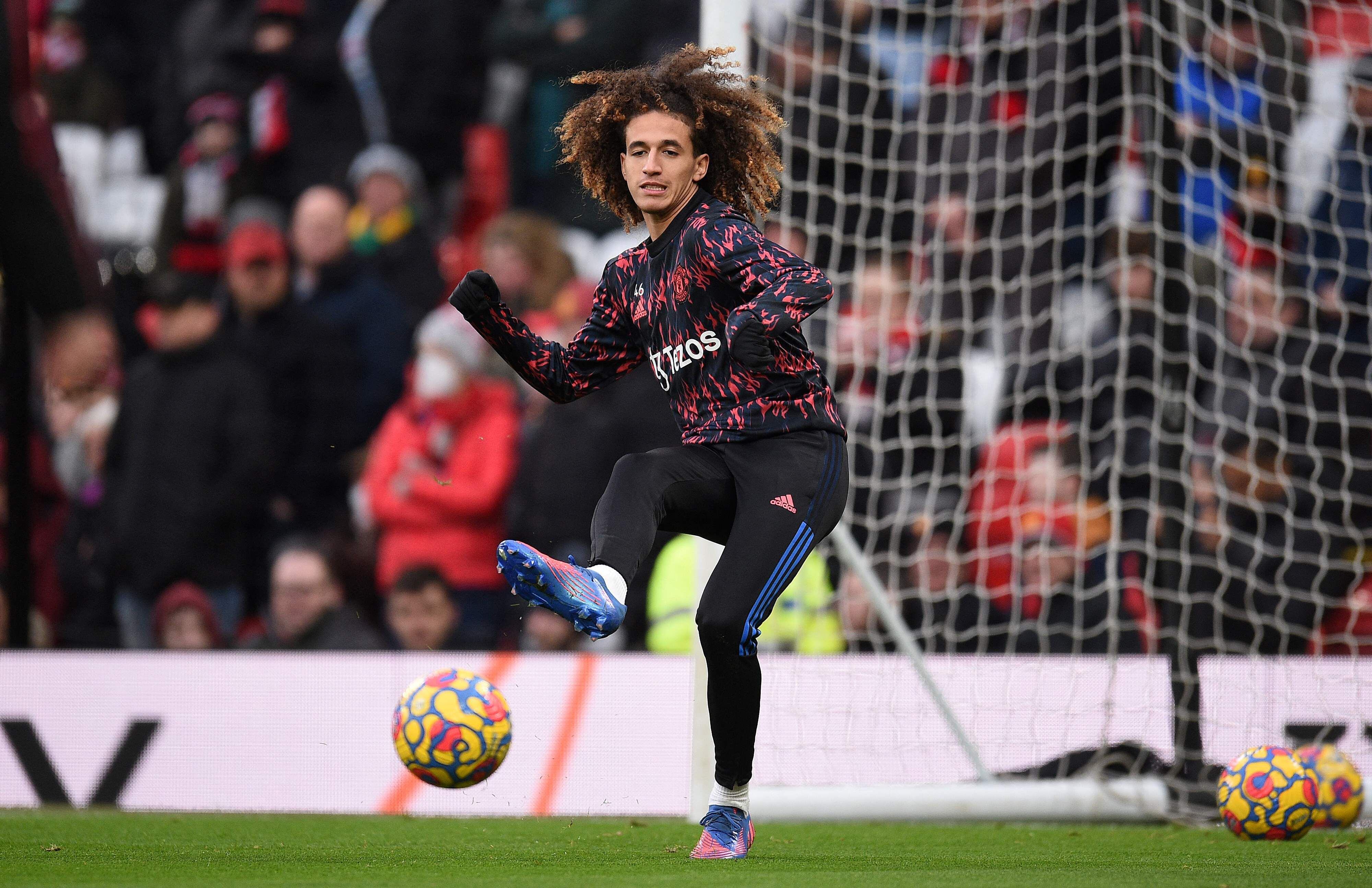Manchester United's Tunisian midfielder Hannibal Mejbri warms up ahead of during the English Premier League football match between Manchester United and Southampton at Old Trafford in Manchester, north west England, on February 12, 2022. (Photo by Oli SCARFF / AFP) / RESTRICTED TO EDITORIAL USE. No use with unauthorized audio, video, data, fixture lists, club/league logos or 'live' services. Online in-match use limited to 120 images. An additional 40 images may be used in extra time. No video emulation. Social media in-match use limited to 120 images. An additional 40 images may be used in extra time. No use in betting publications, games or single club/league/player publications. / 