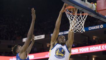 January 23, 2018; Oakland, CA, USA; Golden State Warriors forward Andre Iguodala (9) dunks the basketball against New York Knicks guard Frank Ntilikina (11) during the fourth quarter at Oracle Arena. The Warriors defeated the Knicks 123-112. Mandatory Cre