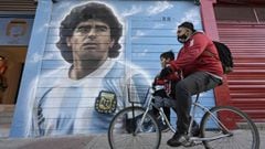 A man rides a bicycle past a mural painted by artist Marley outside the Diego Armando Maradona stadium as people are gathering to commemorate the Argentine legend&#039;s second goal against England during the FIFA World Cup Mexico 1986 on its 35th anniver