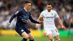 LEEDS, ENGLAND - APRIL 30: Phil Foden of Manchester City controls the ball whilst under pressure from Jack Harrison of Leeds United during the Premier League match between Leeds United and Manchester City at Elland Road on April 30, 2022 in Leeds, England