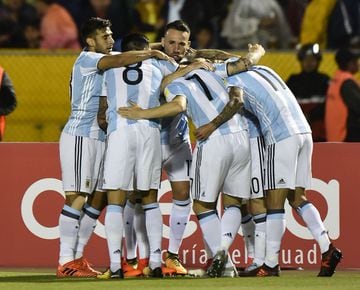Argentina's Lionel Messi (covered) celebrates with teammates after scoring against Ecuador during their 2018 World Cup qualifier football match in Quito, on October 10, 2017.