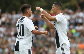 VILLAR PEROSA, ITALY - AUGUST 12: Cristiano Ronaldo (R) of Juventus celebrates with his team-mate Paulo Dybala (L) after scoring the opening goal during the Pre-Season Friendly match between Juventus and Juventus U19 on August 12, 2018 in Villar Perosa, I