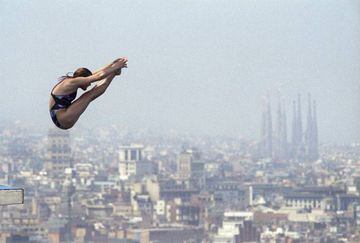 A diver takes to the air during the '92 Olympics with the Sagrada Familia cathedral in the background.